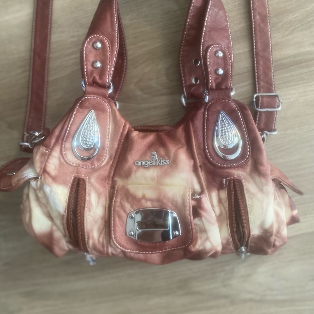 Never used gorgeous leather maroon and white purse. Perfect condition.
